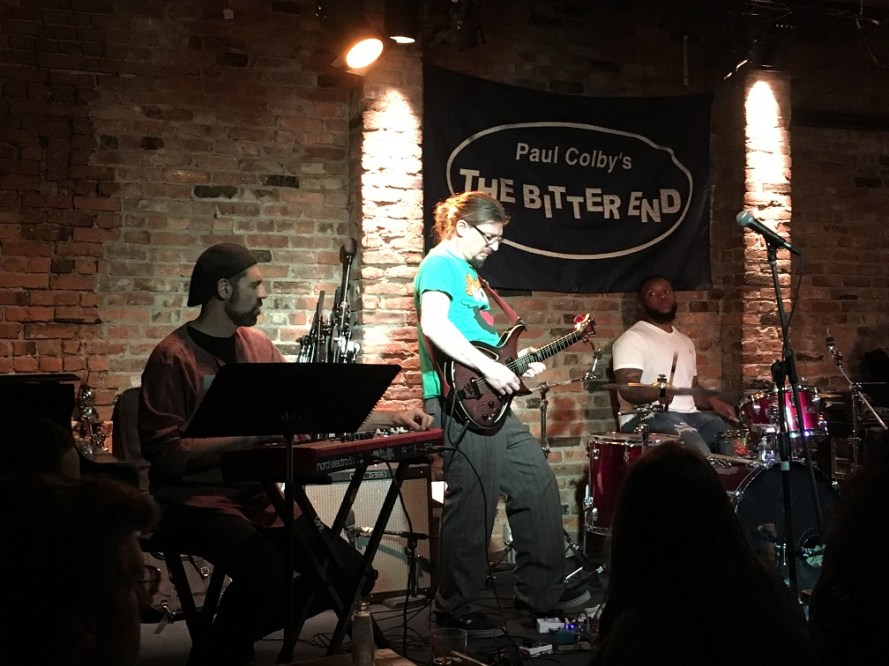 (l-r) keyboardist, lead guitarist, and drummer accompanying Phoebe